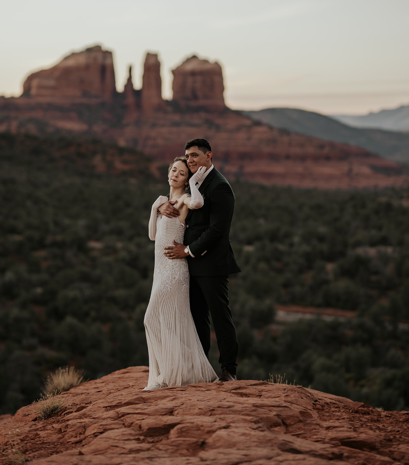 A newlywed couple enjoys sunset at Bell Rock after getting married.